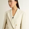 Blazer de mujer en mezcla de lana a rayas blancas y grises con mangas cortas.