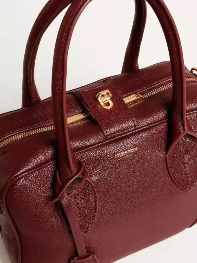 Bolso Vita en piel burdeos con detalles dorados