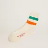 Calcetines blancos con acabado desgastado y rayas verdes y naranjas