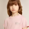 Camiseta rosa para niña con logotipo plateado brillante y estrella maxi