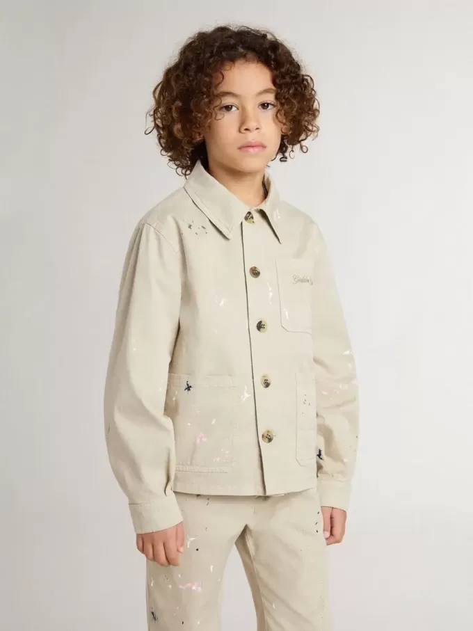 Chaqueta beige para niño con salpicaduras multicolores Chaqueta beige para niño con salpicaduras multicolores