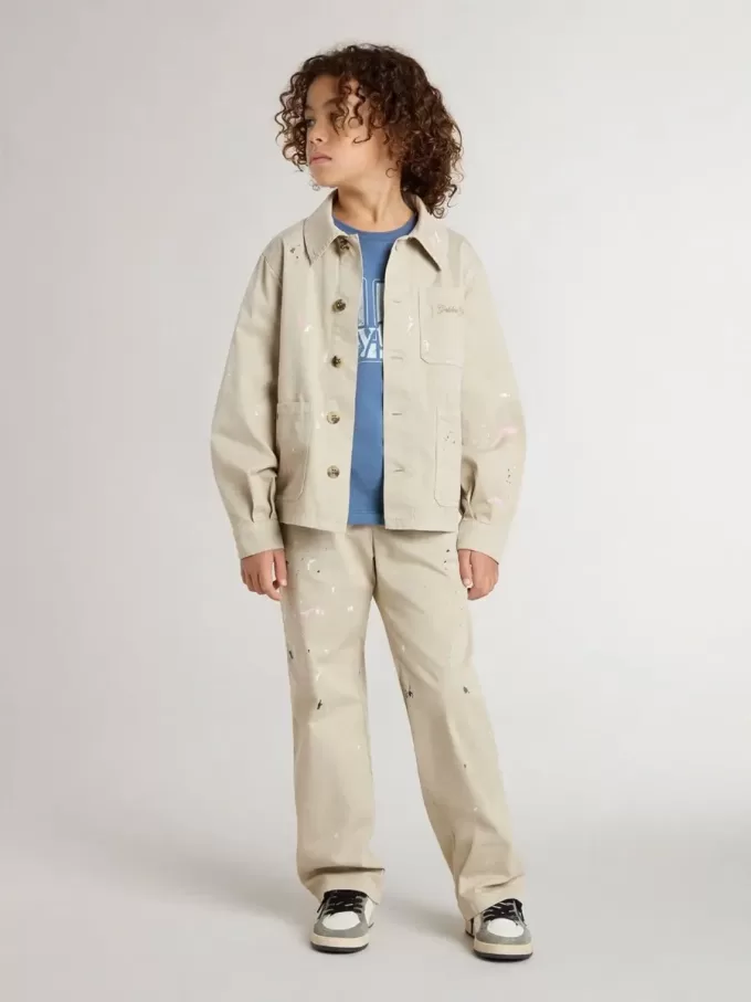 Chaqueta beige para niño con salpicaduras multicolores Chaqueta beige para niño con salpicaduras multicolores
