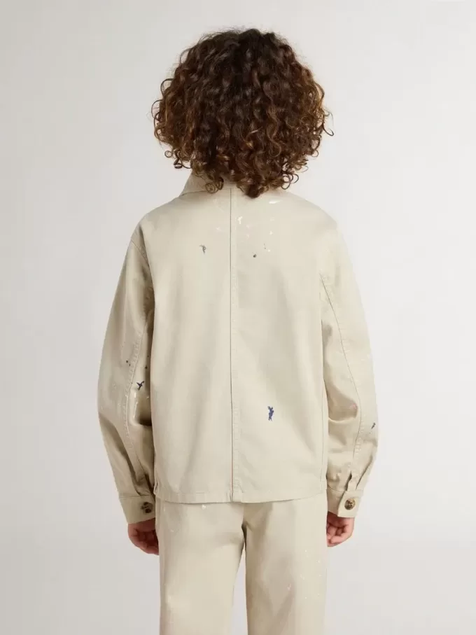 Chaqueta beige para niño con salpicaduras multicolores Chaqueta beige para niño con salpicaduras multicolores