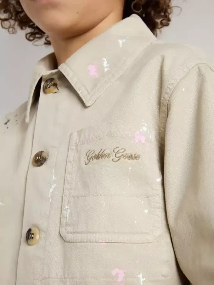 Chaqueta beige para niño con salpicaduras multicolores Chaqueta beige para niño con salpicaduras multicolores