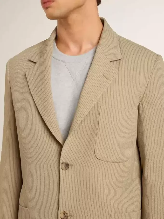 Chaqueta de hombre beige a rayas con un corte oversize y botonadura sencilla. Chaqueta de hombre beige a rayas con un corte oversize y botonadura sencilla.