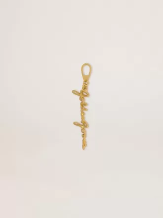 Dije de latón dorado con la firma Golden Goose