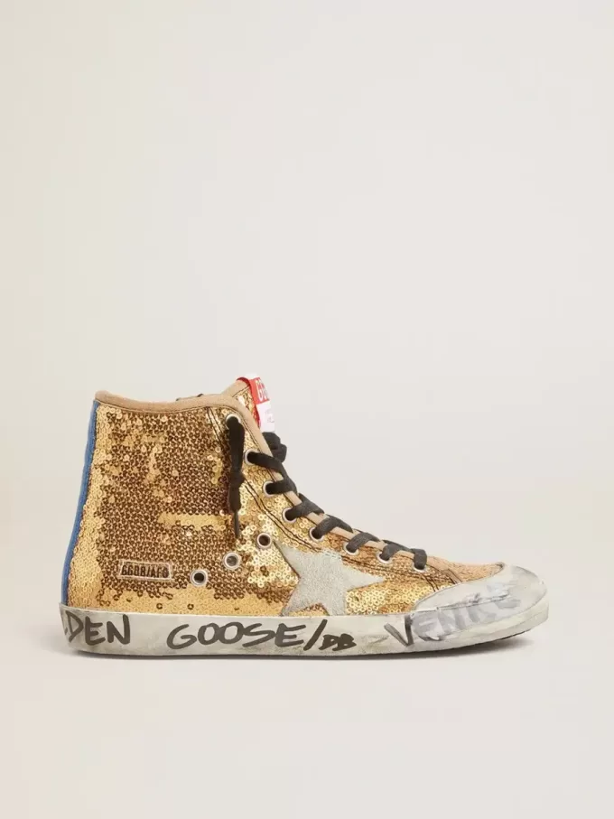 Francy Penstar en lentejuelas doradas con estrella de ante y lengüeta azul brillante en el talón