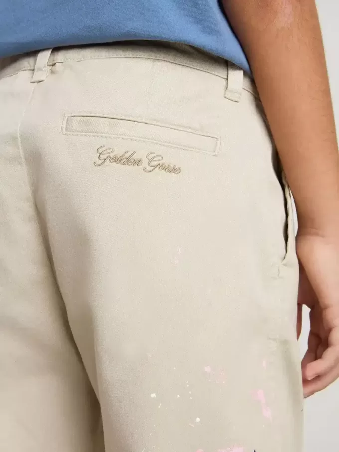 Pantalones chinos beige para niño con salpicaduras multicolores