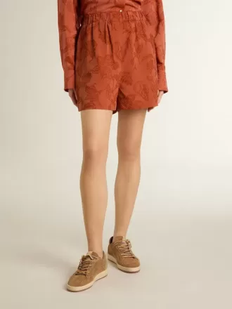 Pantalones cortos de mujer en jacquard rojo ladrillo con estampado floral marino Pantalones cortos de mujer en jacquard rojo ladrillo con estampado floral marino