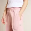 Pantalones de chándal rosas con estrella brillante en la parte delantera.