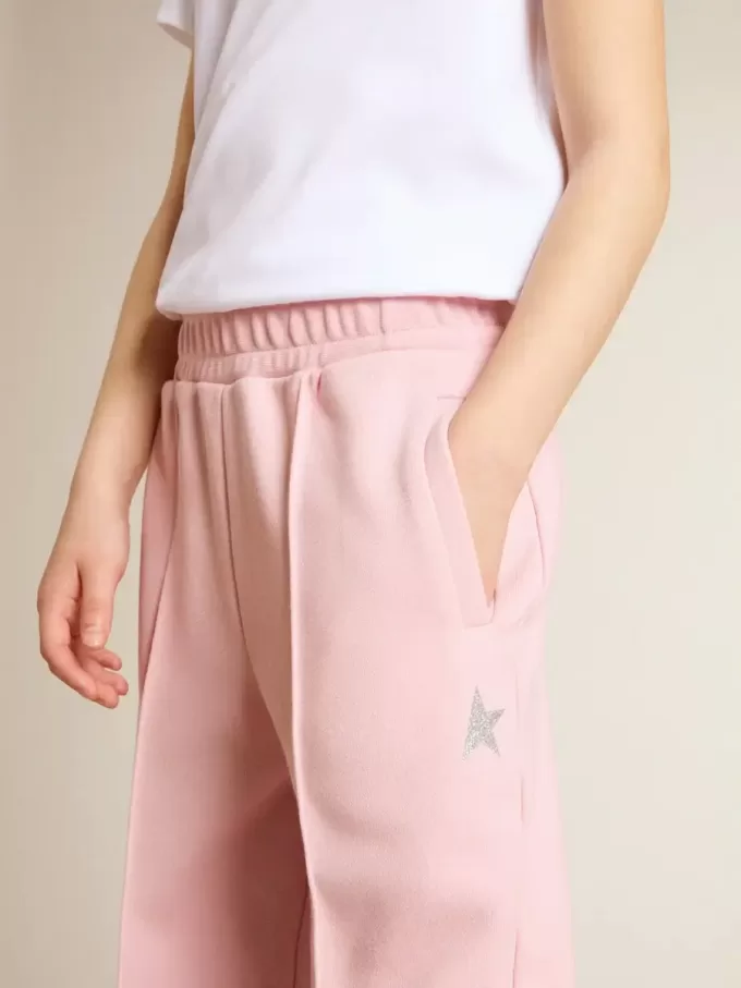 Pantalones de chándal rosas con estrella brillante en la parte delantera.