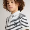 Polo blanco de algodón para niño con rayas azul marino y bordado Polo blanco de algodón para niño con rayas azul marino y bordado