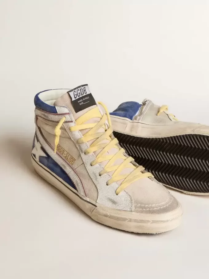 Slide en lona perlada y ante azul con estrella y flash de cuero blanco Slide en lona perlada y ante azul con estrella y flash de cuero blanco