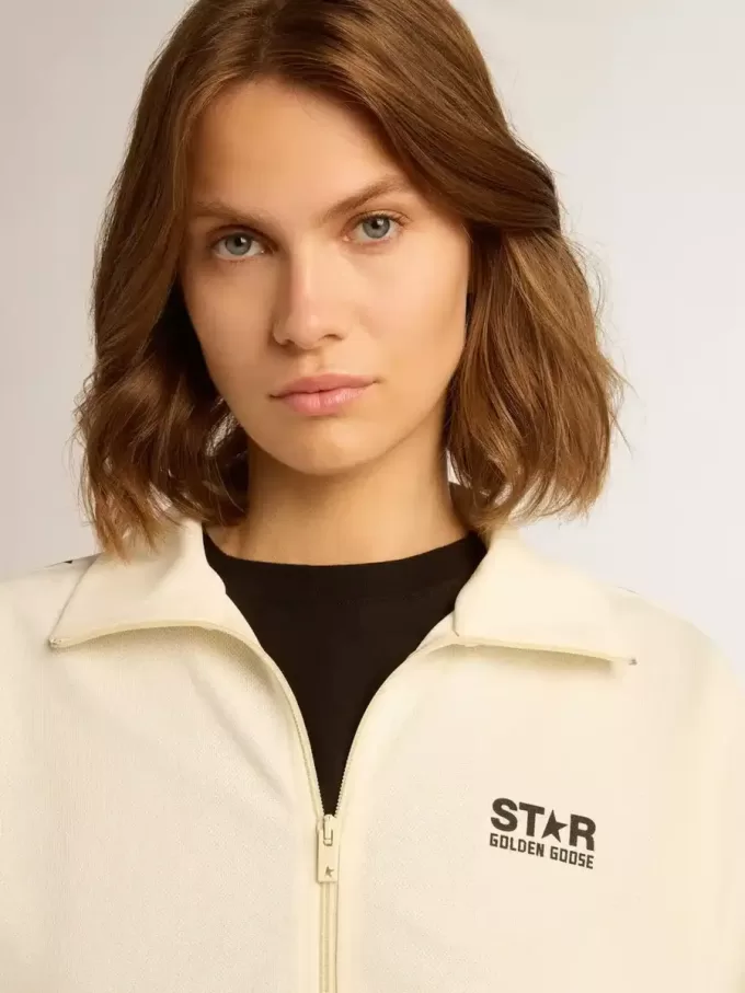 Sudadera blanca con cremallera para mujer con franja blanca y estrellas negras