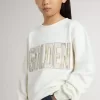 Sudadera blanca para niña con inscripción multicolor «Golden» en la parte delantera