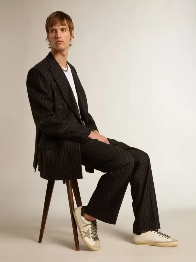 Super-Star LTD con estrella con estampado de cocodrilo y lengüeta verde en el talón.