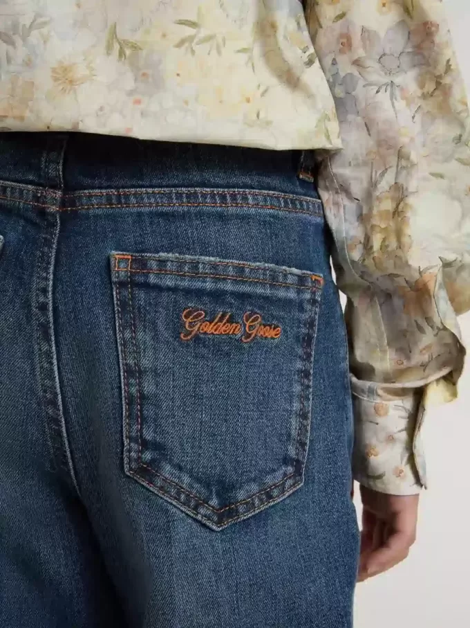 Vaqueros bootcut para niña con lavado medio y bordados