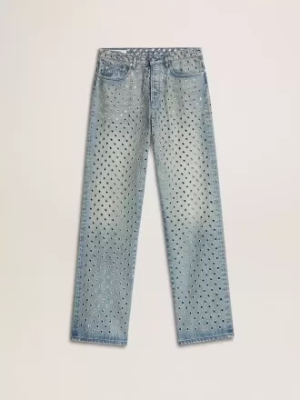 Vaqueros lavados para mujer con ojales en toda la prenda